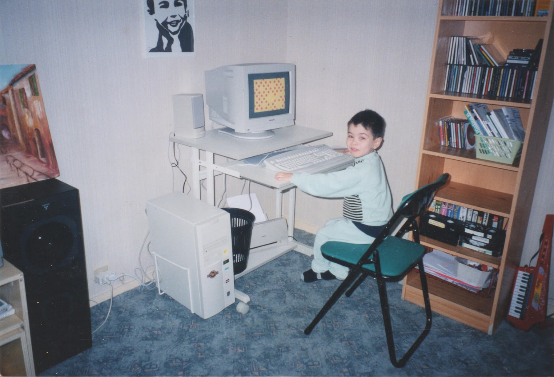 A 4 year old me playing with an old school computer.